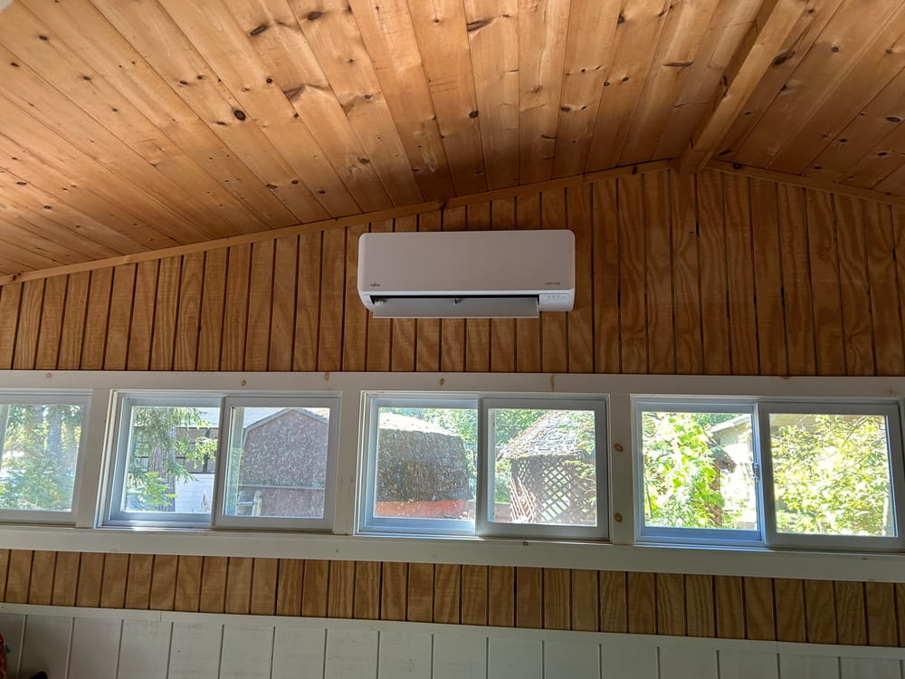 A ductless mini-split installed in a wooden cabin.